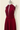 Collier doré porté sur robe Prestance bordeaux - By Louise